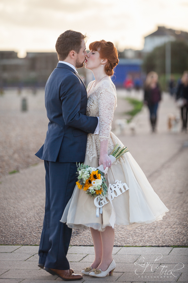 bride and groom kiss on beach